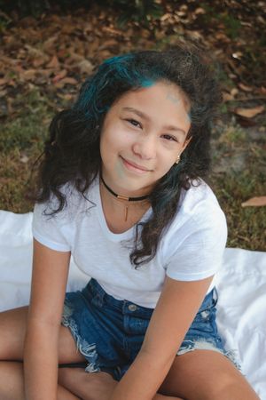 A series of outdoor portrait photos on a white blanket with fallen autumn leaves in the background.
