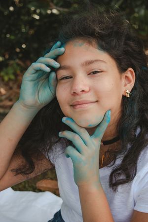 A sequence of playful poses showing someone wearing blue medical gloves and a white t-shirt against a natural background.