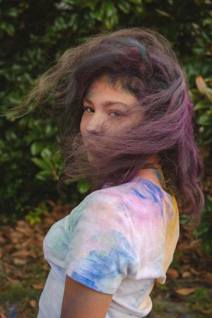 Motion shots capture a playful moment with powder paint creating swirls of blue and purple in the air.