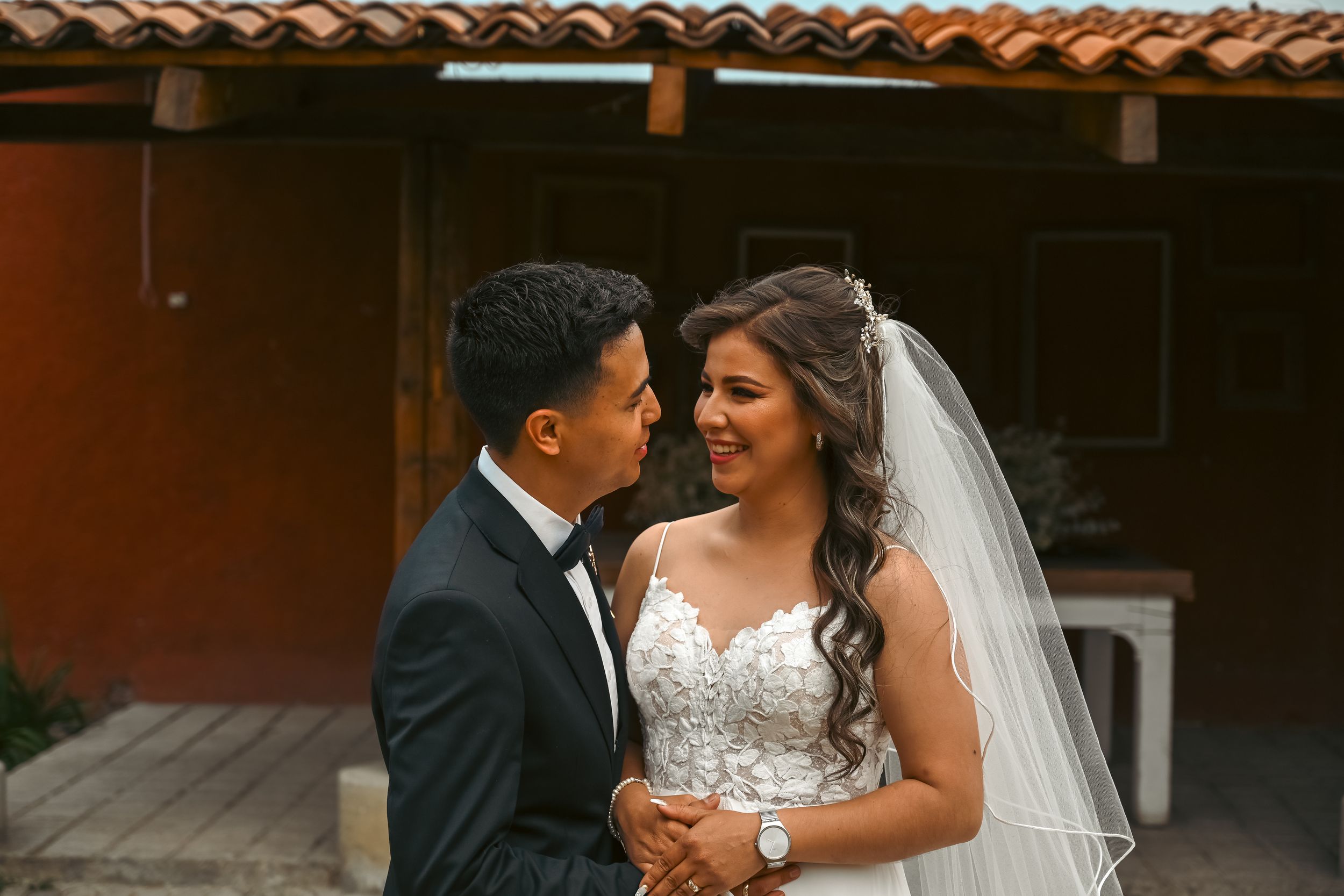 Intimate wedding moments captured under a Spanish-style covered walkway.