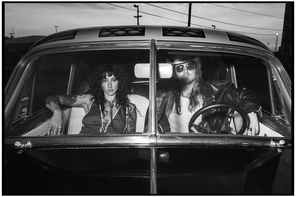 Black and white photo of friends inside vintage car at night. Portland portrait photographer