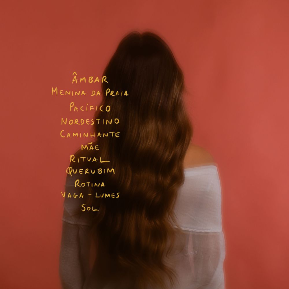 A silhouette of long wavy hair against a reddish-orange background with handwritten text overlay.