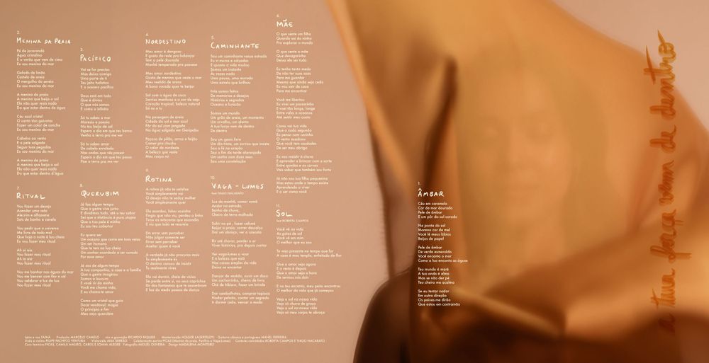Wedding seating chart or program printed on soft golden fabric with elegant typography.