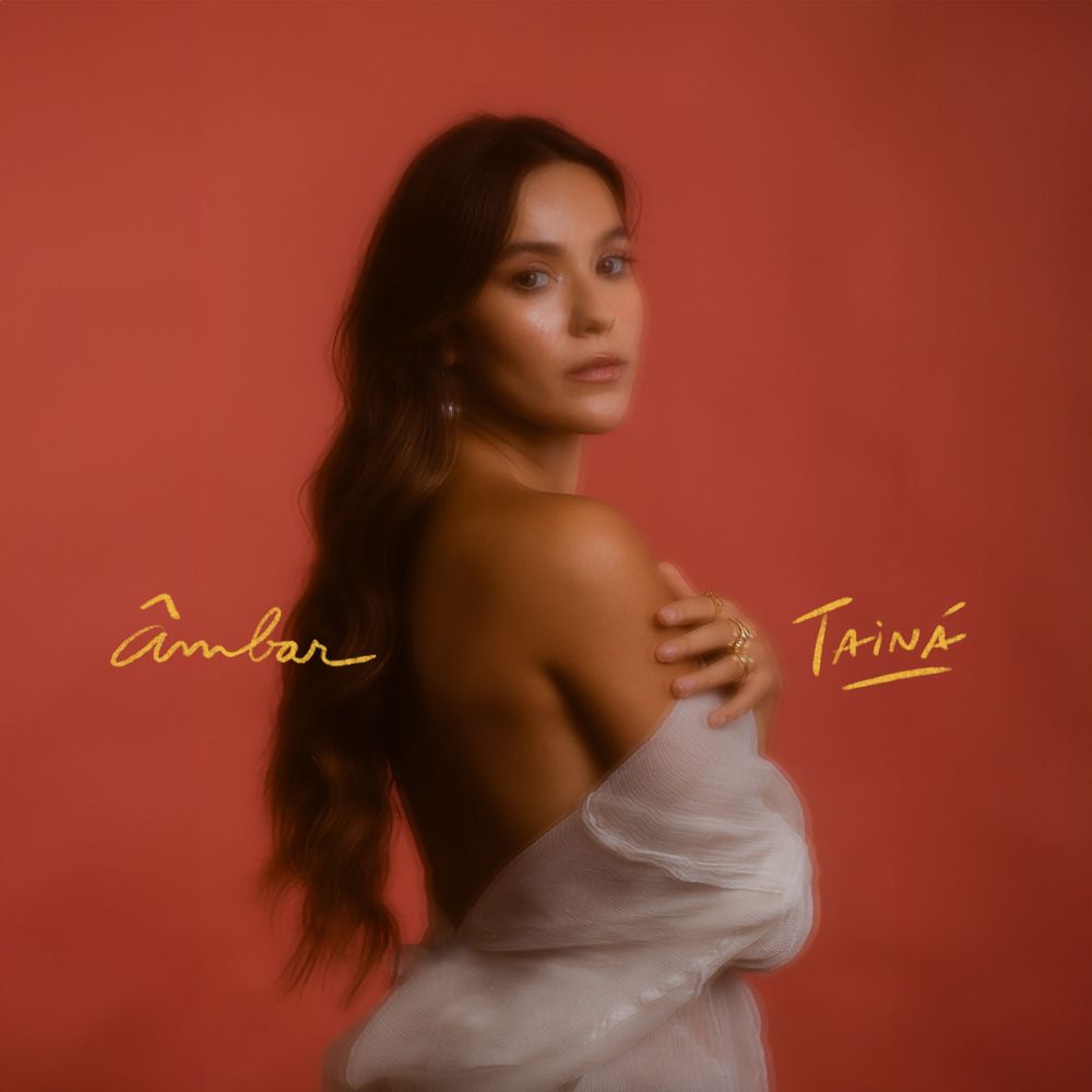 Contemporary album art features a profile against a warm red background with gold text at the bottom corners.