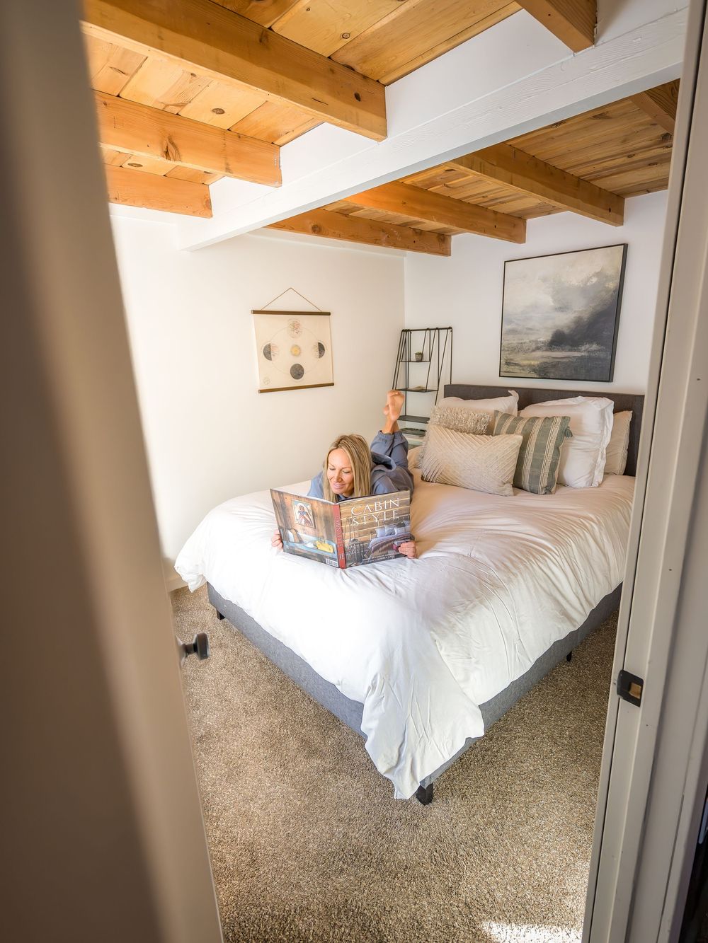 Woman reading a book on the bed by Denver Hospitality, Travel & Tourism photographer Captain Colorado Photography.