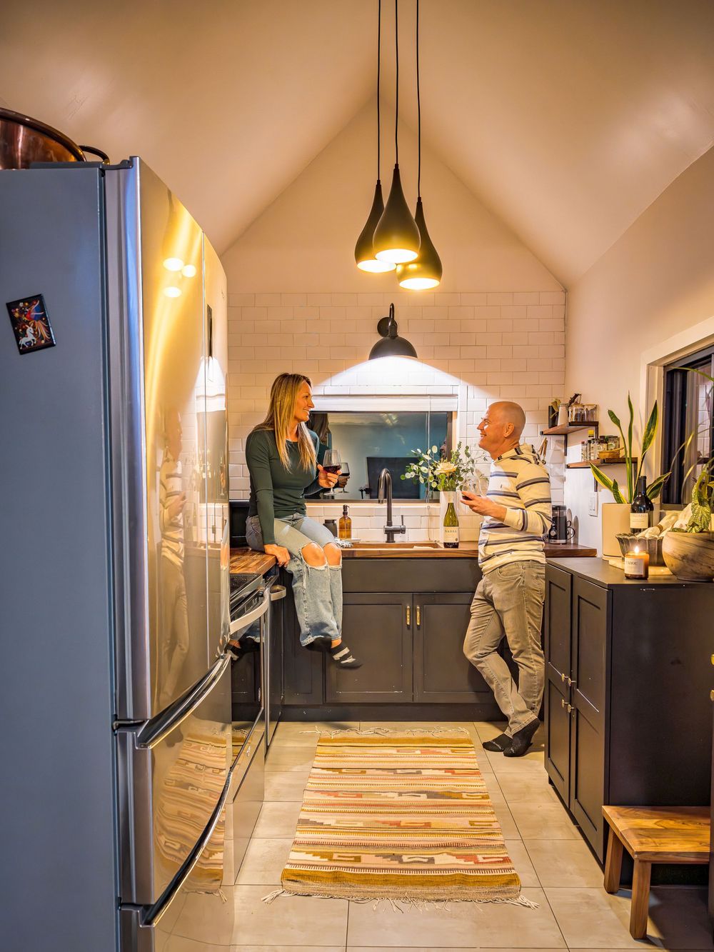 Couple enjoying an evening with wine in the kitchen by Denver Hospitality, Travel & Tourism photographer Captain Colorado Photography.