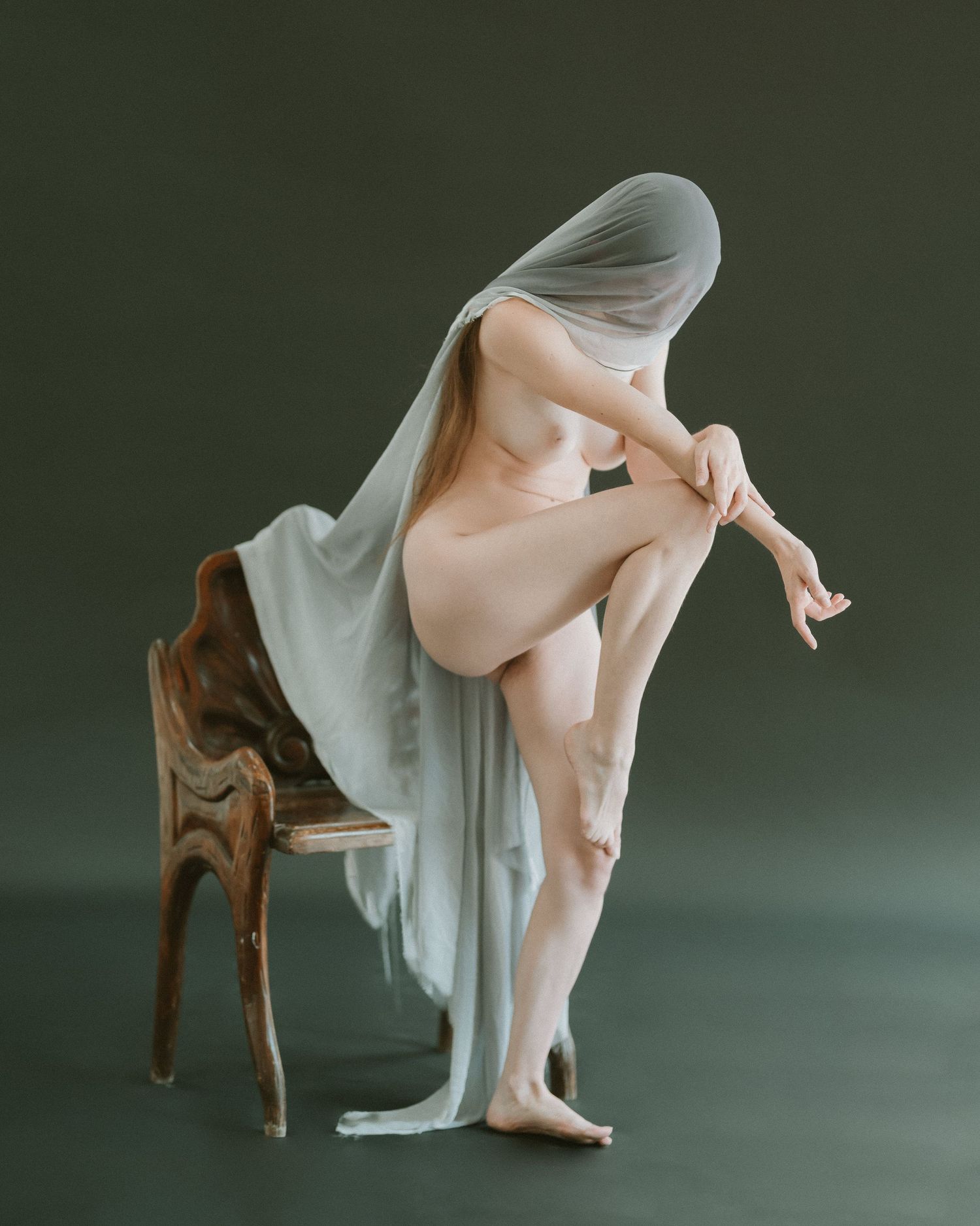 Dramatic figure study with flowing fabric showing dance-like movement.