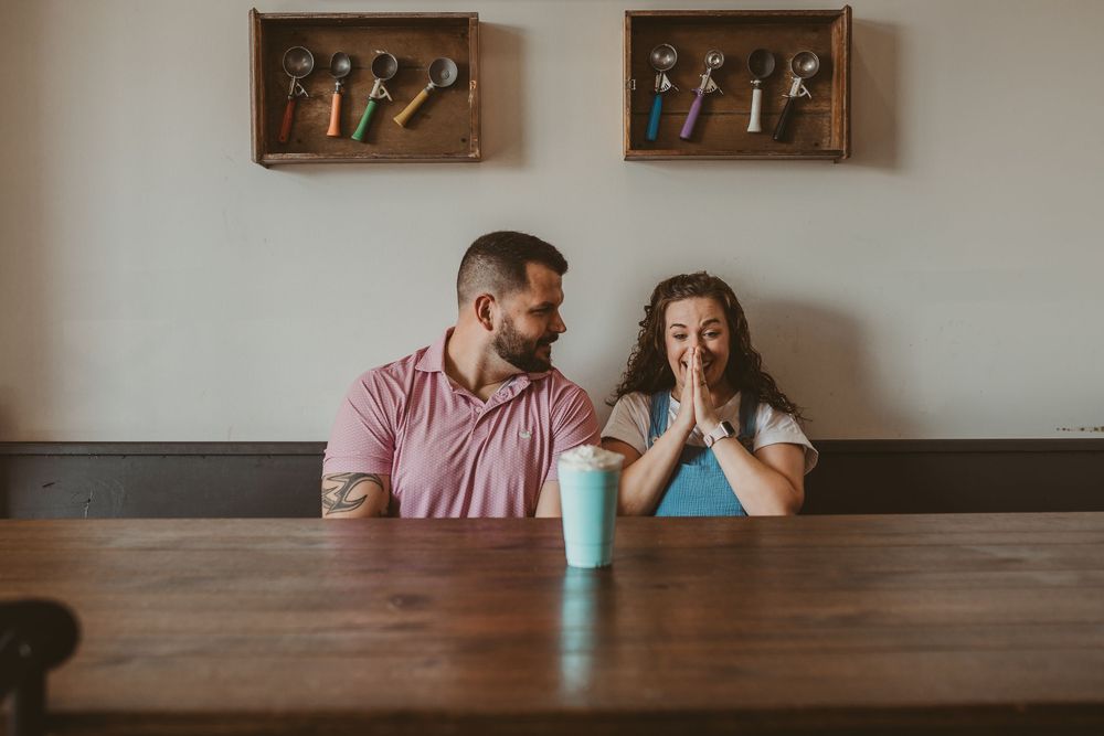 Two people sit at a wooden dining table with a turquoise tumbler, shown from multiple angles in a photo series.