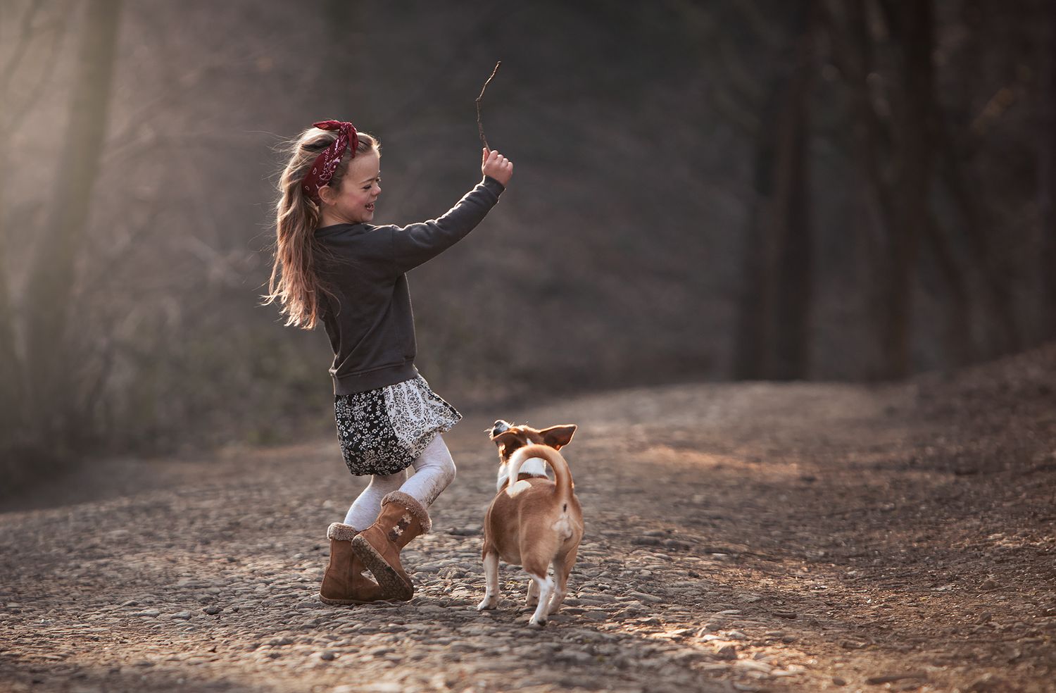 dog and daughter playing golden light