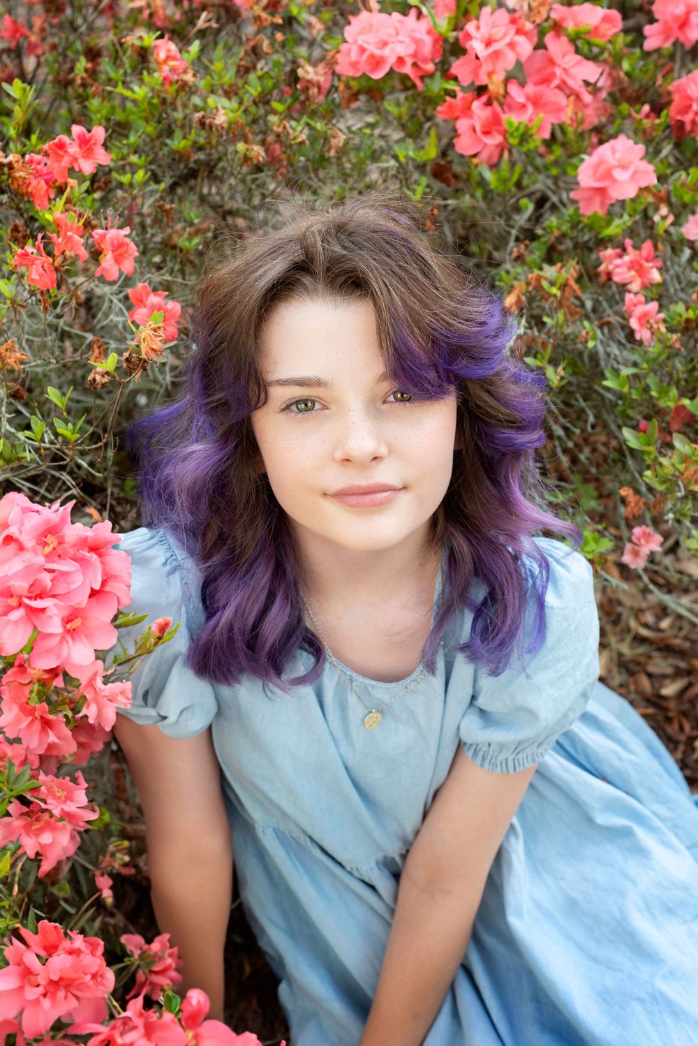Child glamor portrait session surrounded by flowers outside during golden hour in Gainesville Florida at the Thomas Center