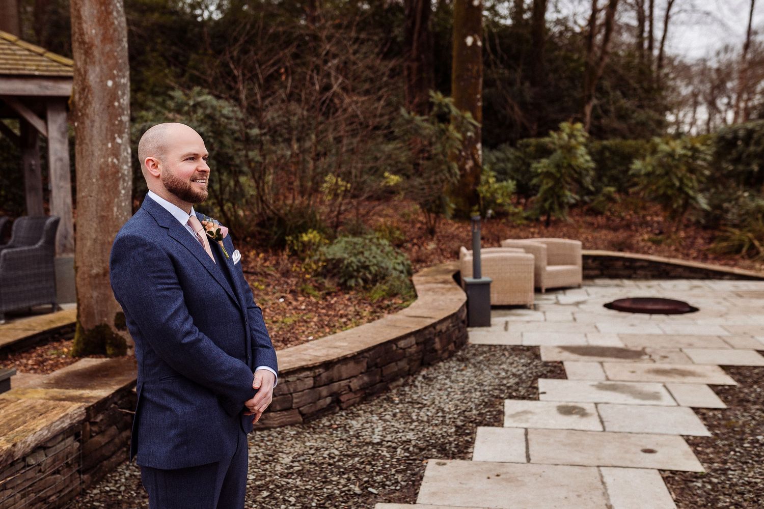 Groom standing by the boathouse at Storrs Hall before the ceremony