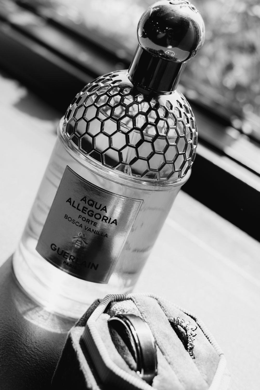 Guerlain Aqua Allegoria Forte Bosca Vanilla perfume bottle in black and white with honeycomb design.