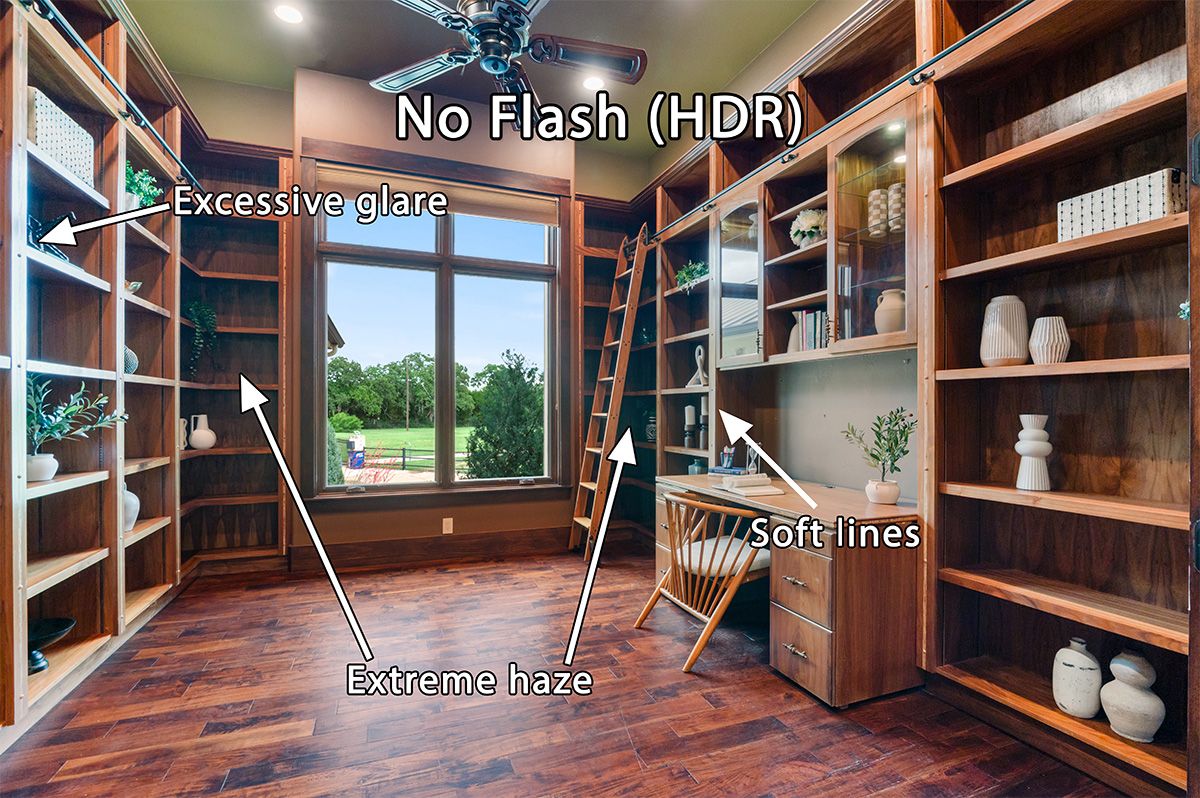HDR home library with wood bookshelves, rolling ladder, hardwood floors, and large window overlooking green landscape.