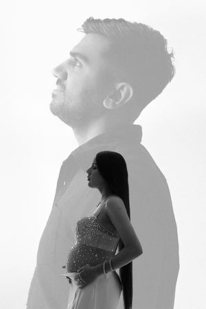 Multiple silhouettes of a person in profile against a white background create an artistic shadow effect.