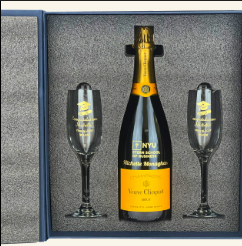 Veuve Clicquot champagne gift set with personalized bottle and two engraved flutes in a navy blue box.