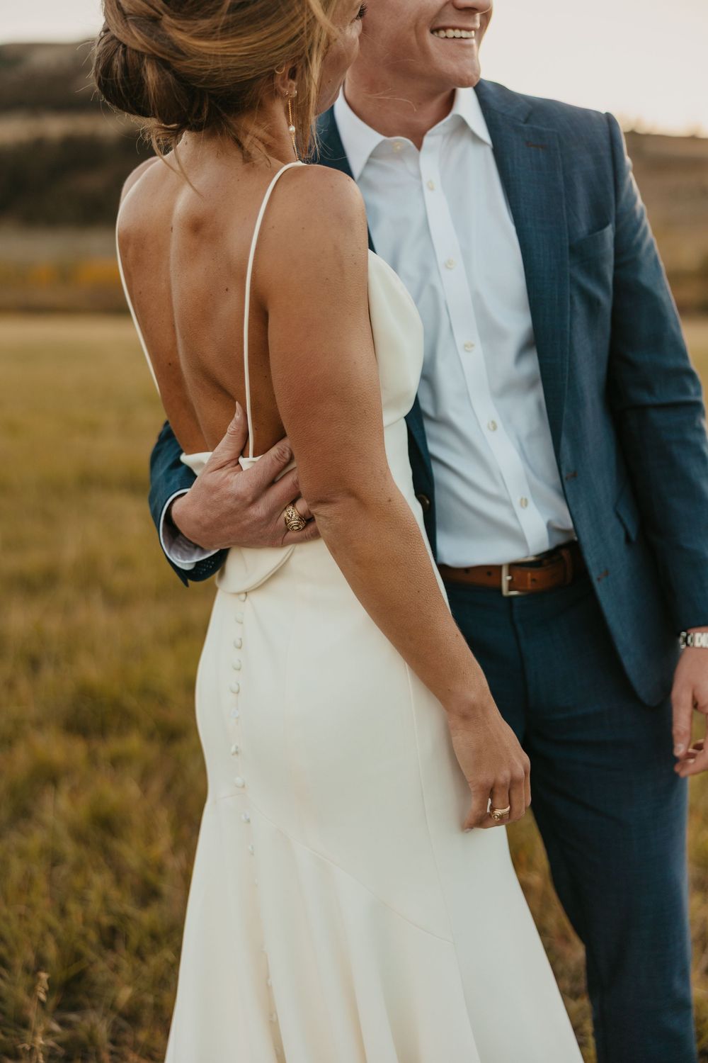 Couple embracing at sunset at Grizzly Creek Ranch Wedding in Emigrant Montana captured by Pray Montana Wedding Photographer in Mountains