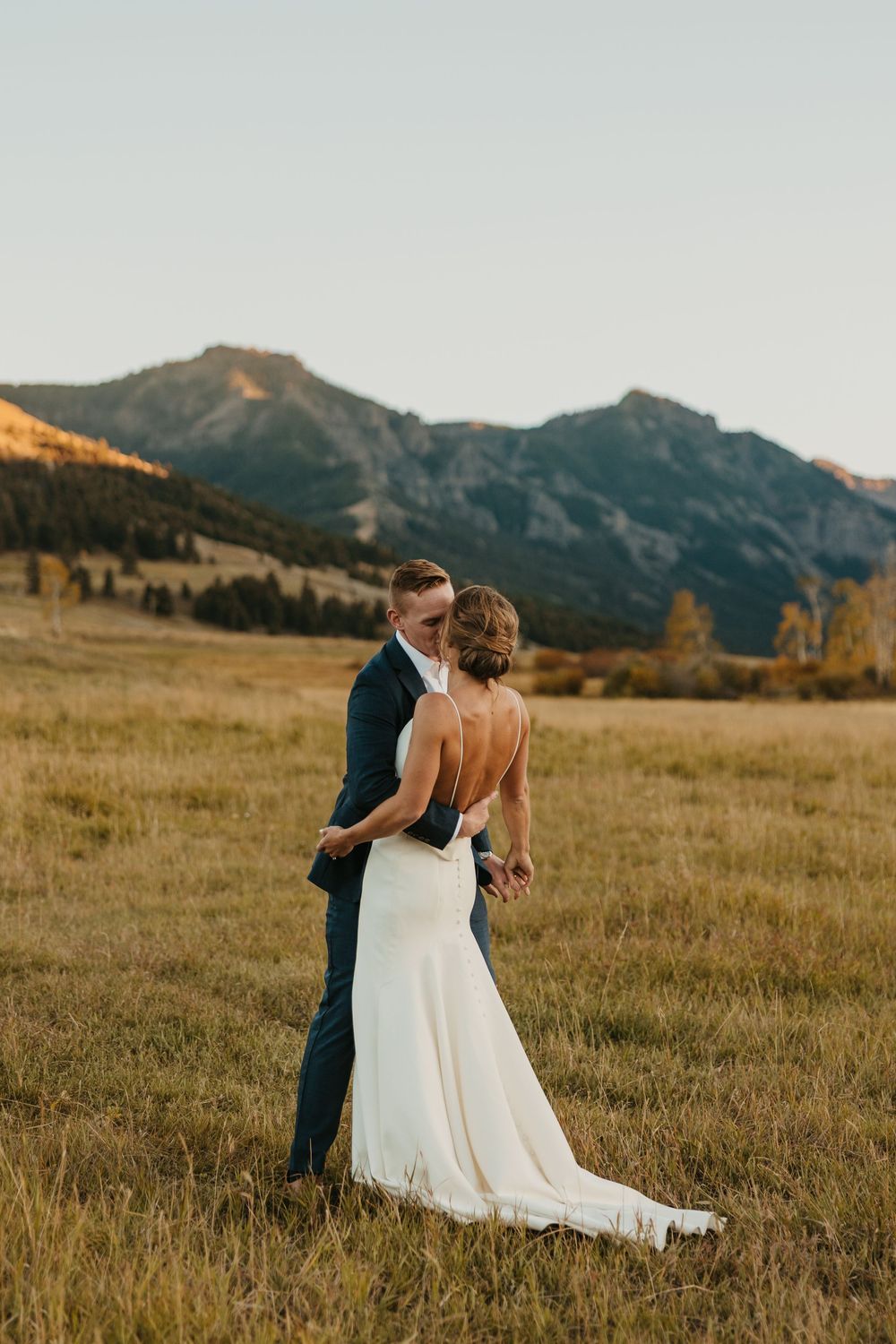 Couple kissing at sunset at Grizzly Creek Ranch Wedding in Emigrant Montana captured by Pray Montana Wedding Photographer in Mountains