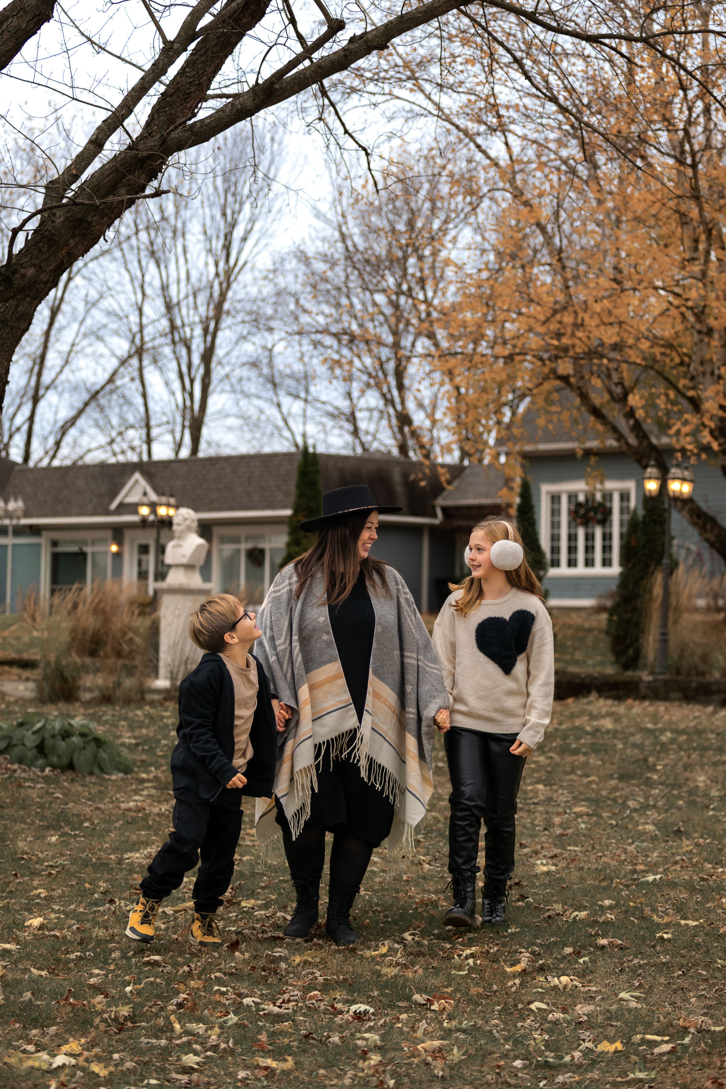 A series of candid family photos taken outdoors in autumn with fallen leaves on the ground.