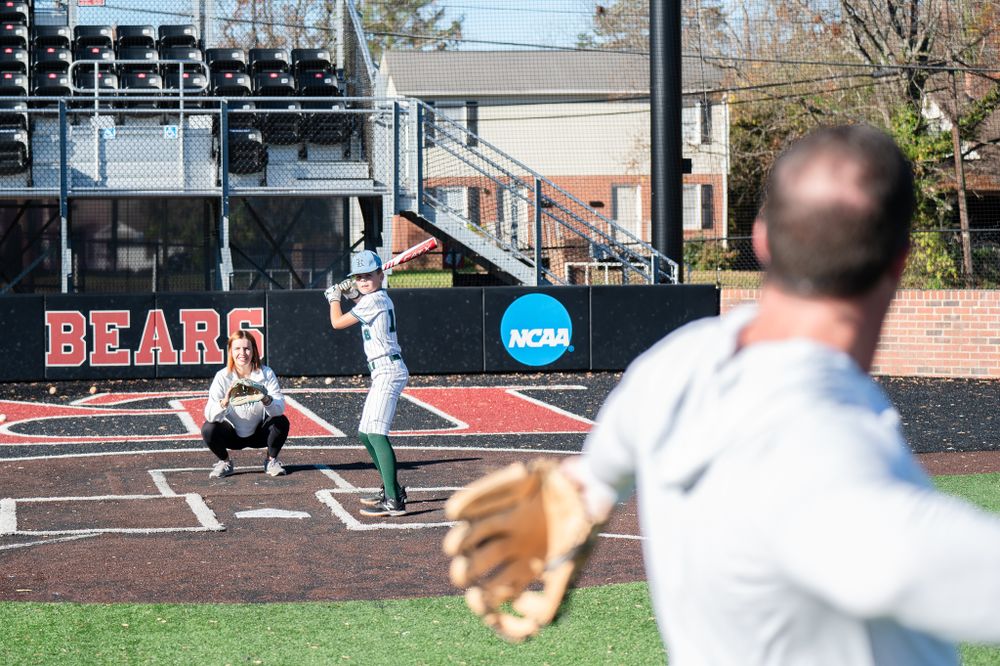 Baseball game in progress at field with Bears signage and scoreboard visible in background.