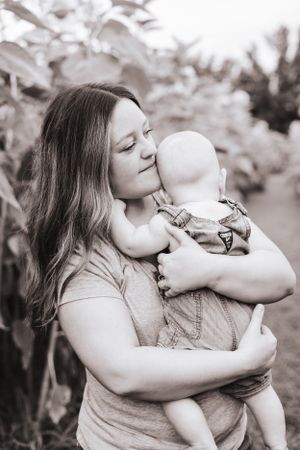 Intimate black and white portrait of tender family moments outdoors.