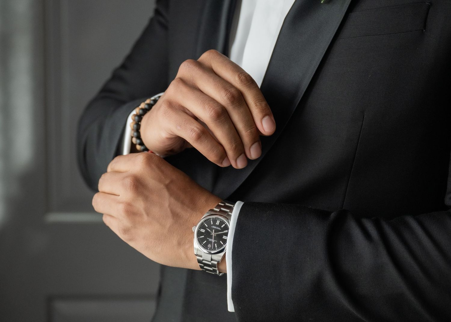 A groom on his wedding day getting ready in his tuxedo