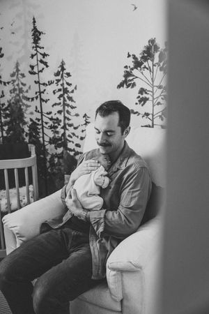 Black and white series of tender moments between parent and baby near window.