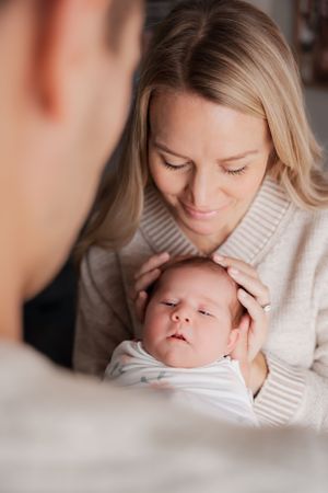 Tender moment captured in soft lighting with baby.