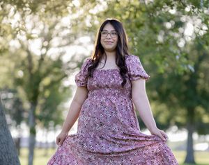 Outdoor portrait of model twirling her dress duiring golden hour.
