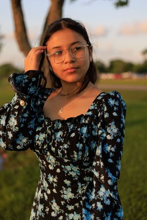 Outdoor golden hour portrait with floral dress.