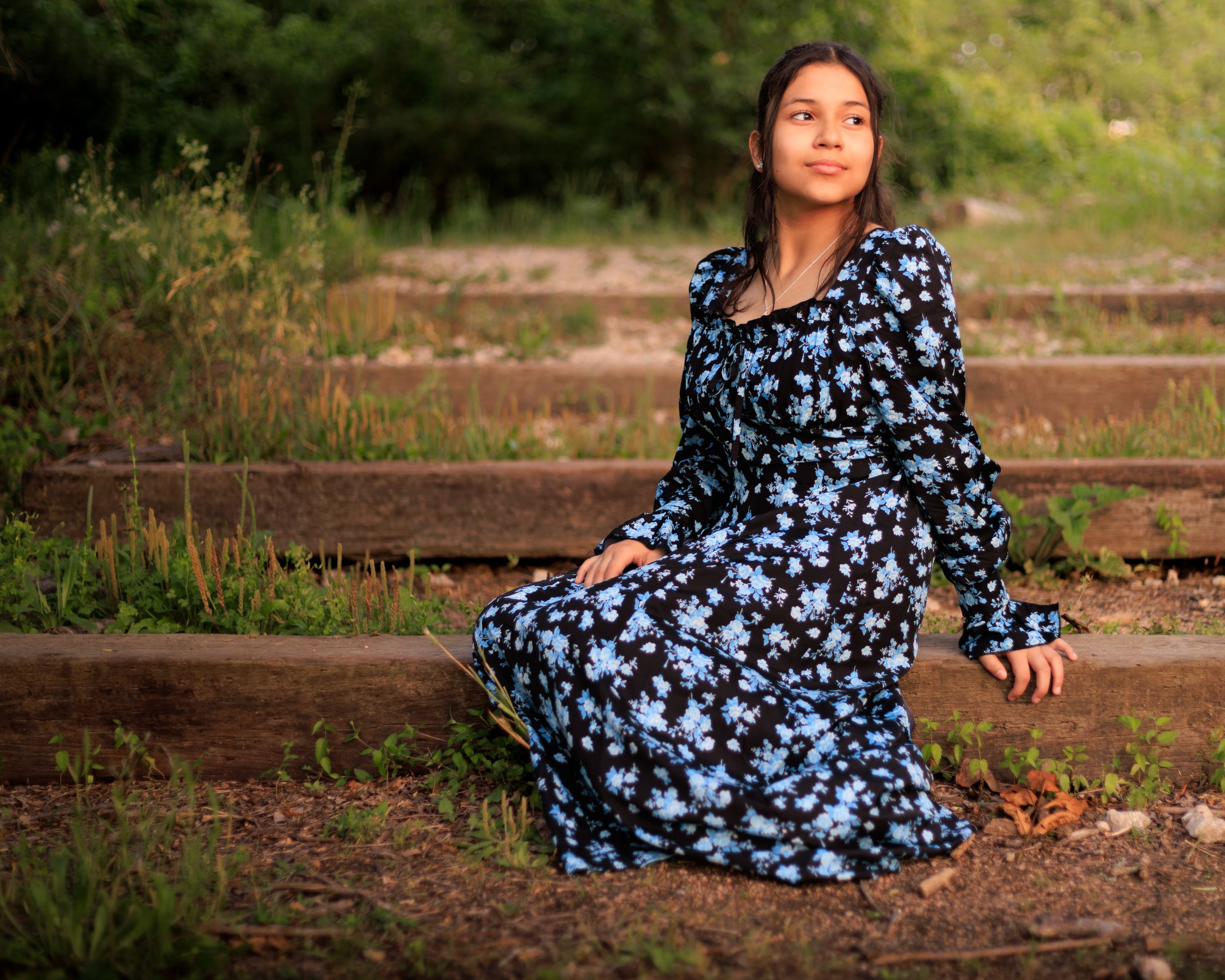 Outdoor session with model looking at the golden hour, showing her dress.