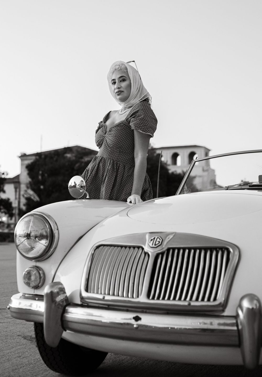 Vintage MG sports car shown in detail with its distinctive chrome grille and headlights.