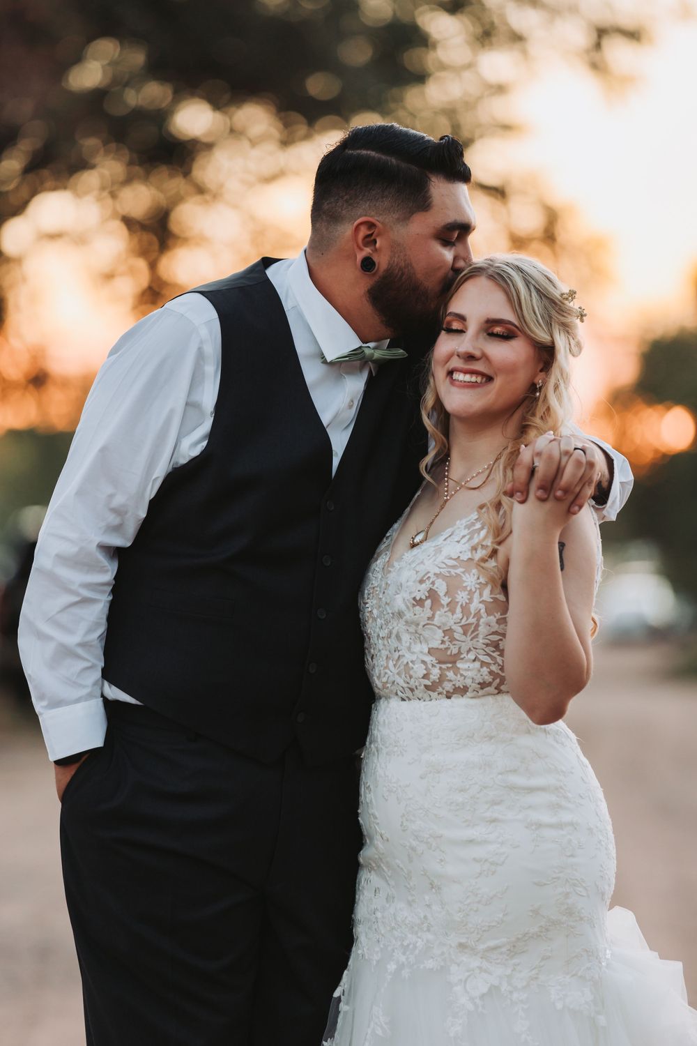 A tender moment between newlyweds during golden hour outdoor wedding portraits.