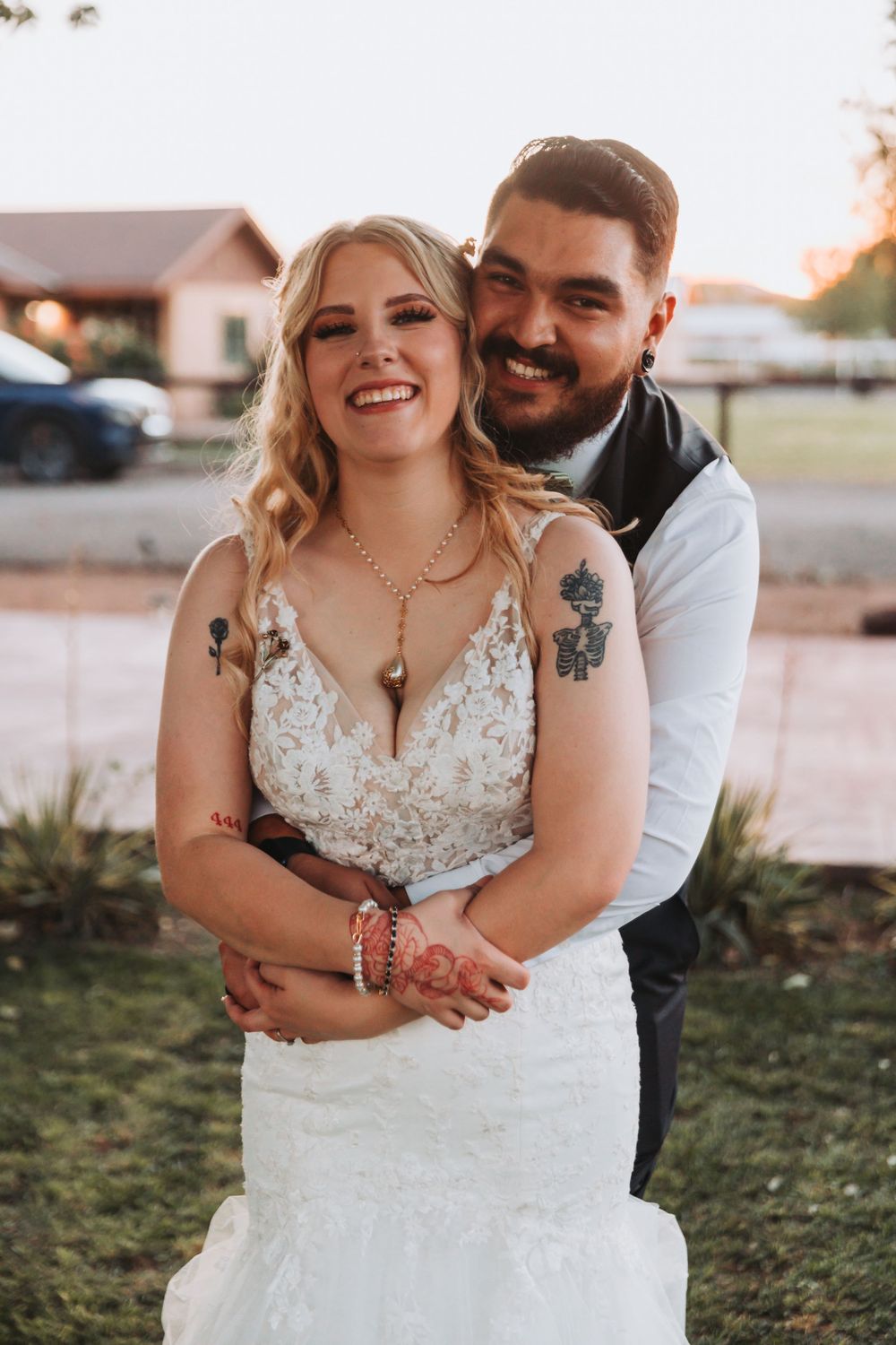 Romantic embrace between newlyweds during sunset wedding portraits.