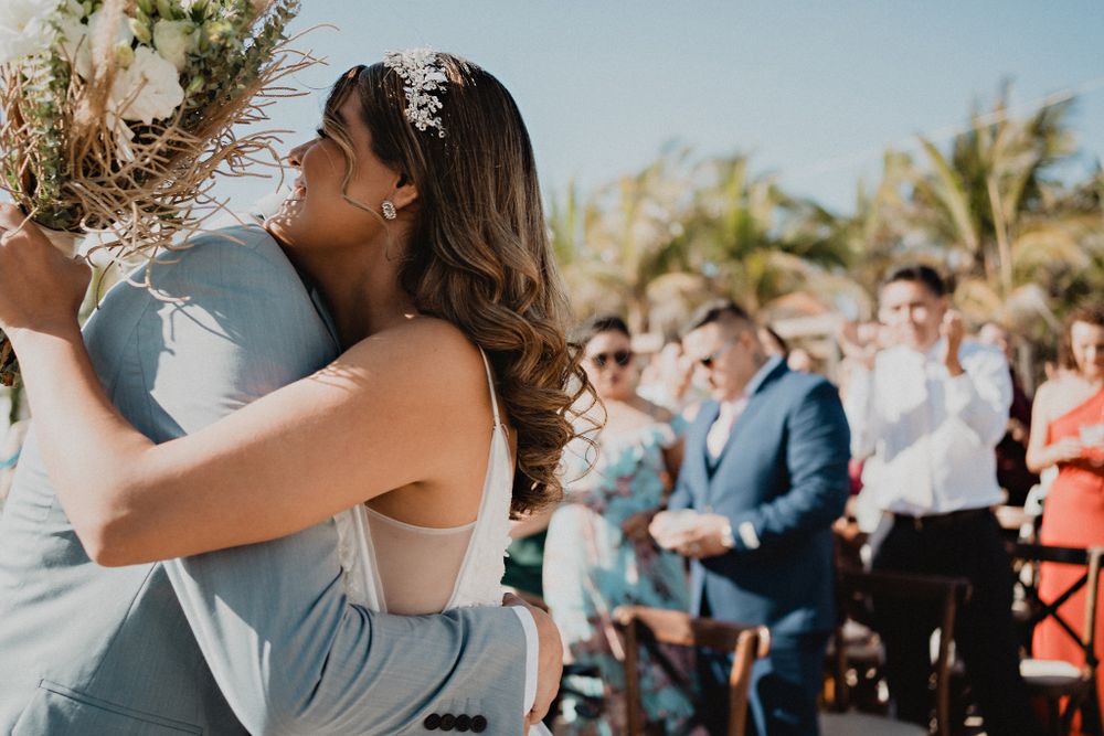 Couple embracing at the altar, an emotional moment of love captured during their wedding ceremony