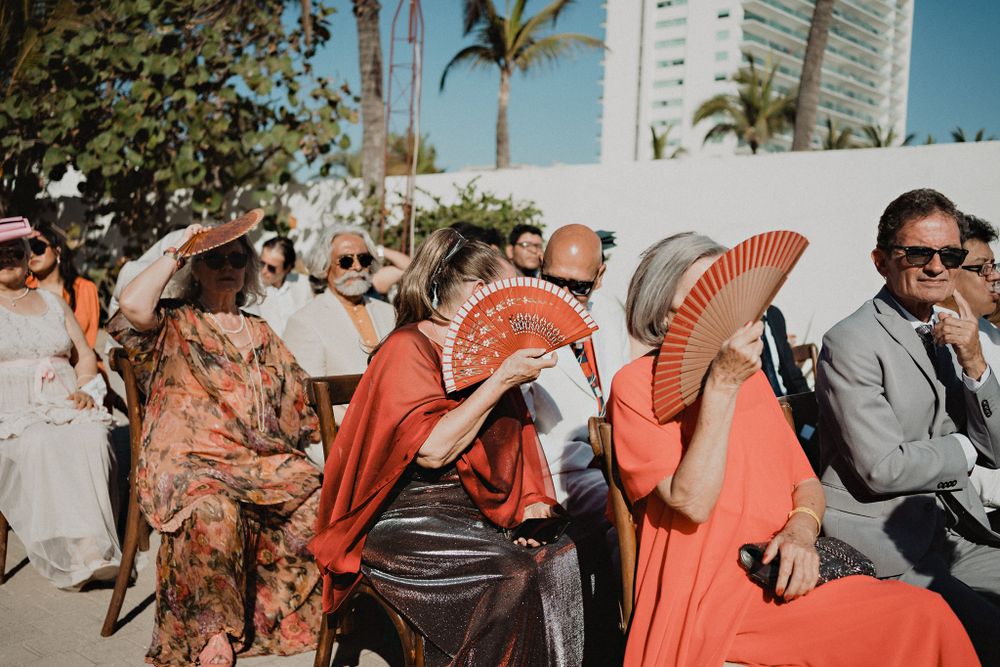 Wedding guests enjoying the ceremony, adding to the celebration of love at this destination wedding