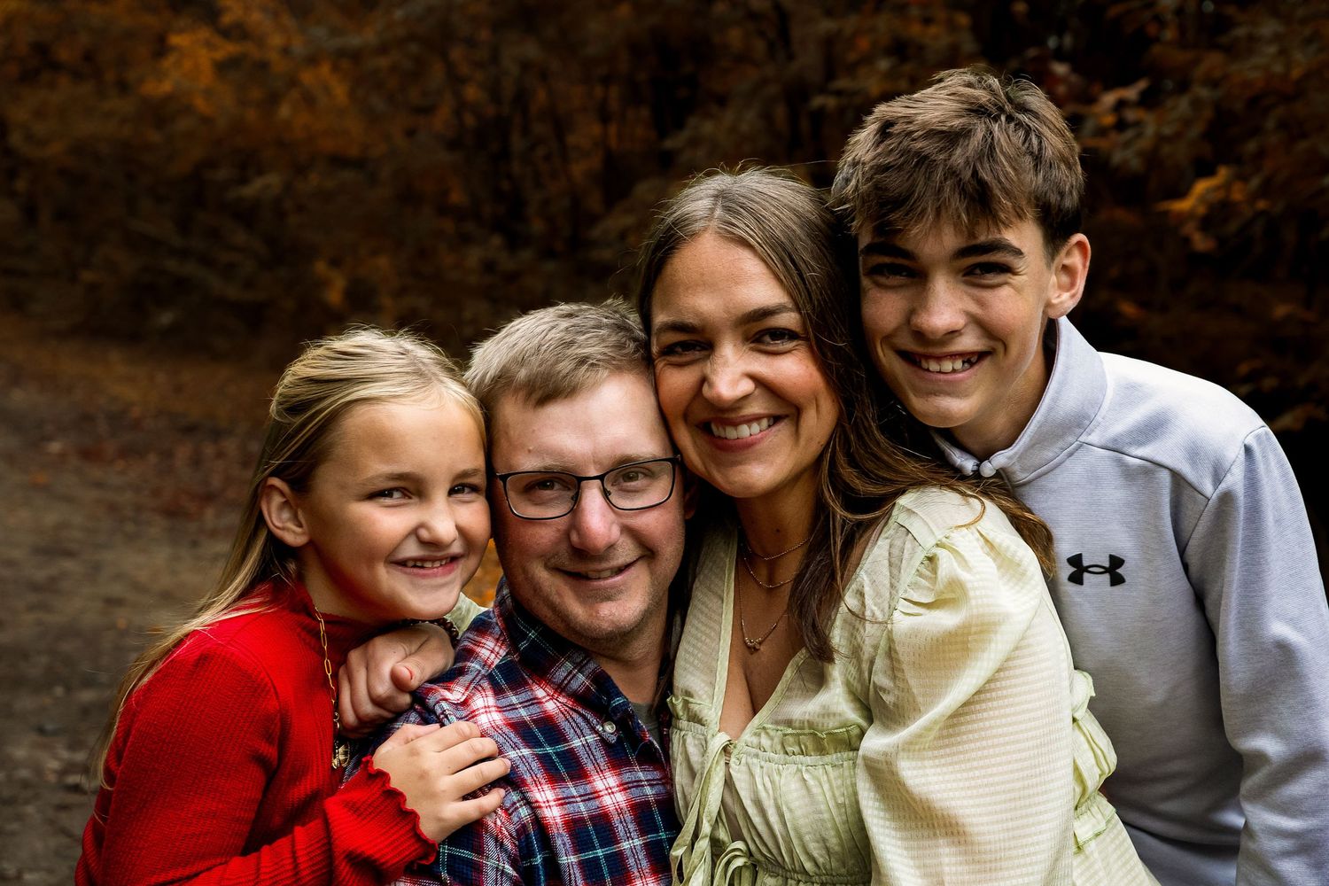 A series of candid outdoor family portraits showing joyful moments and laughter against a natural background.
