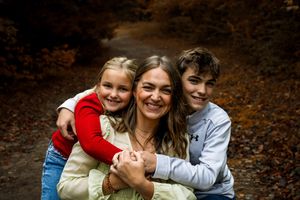 A series of candid family photos showing joyful embraces and laughter in an autumn forest setting.