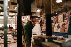 Interior of vintage record store with rows of albums and overhead lighting.