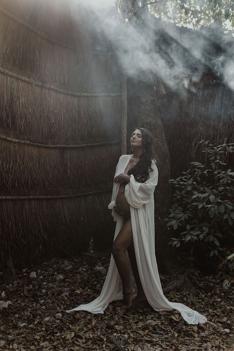 Elegant maternity photoshoot in Tulum with flowing white tunic.