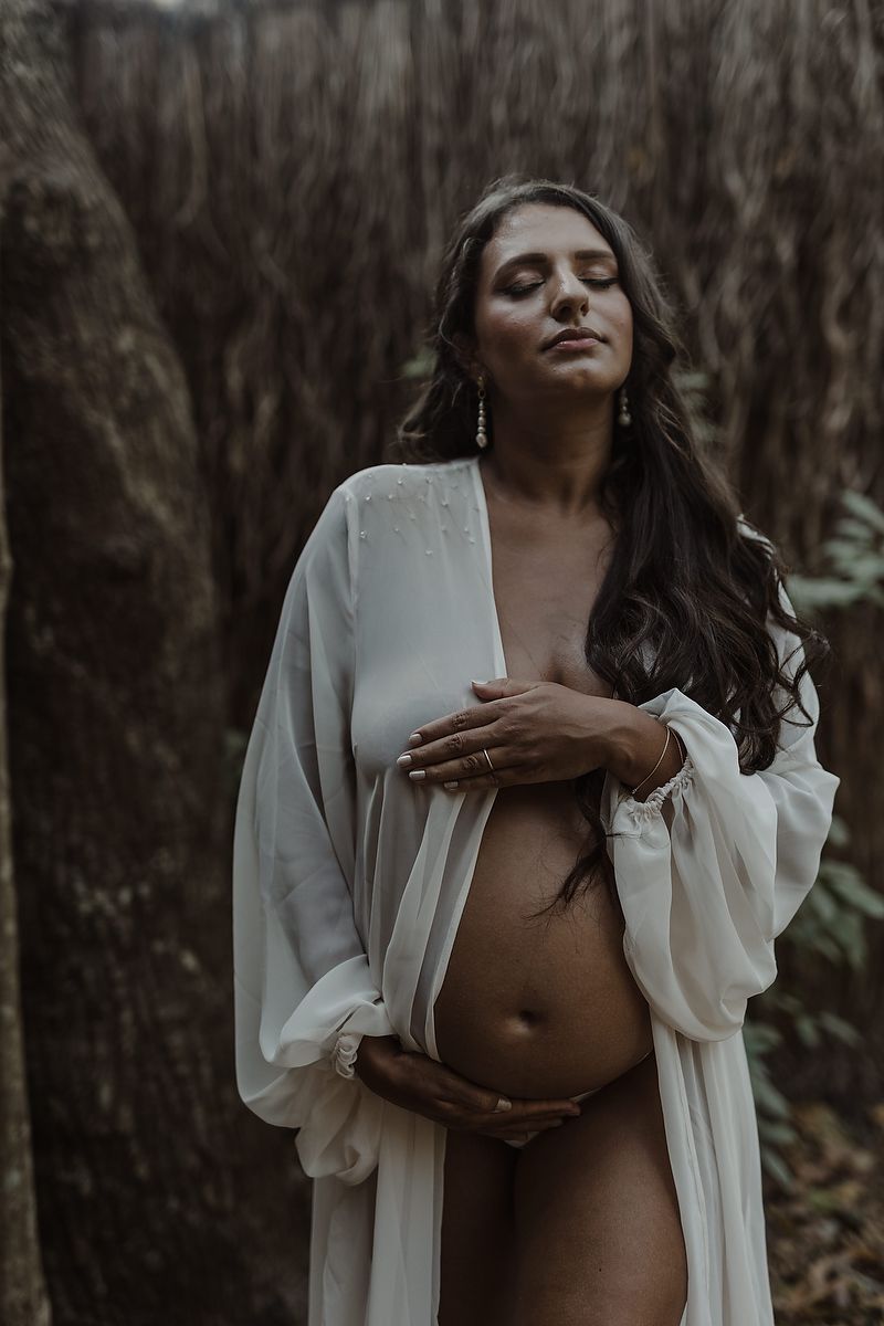 Baby bump close-up during pregnancy session in Riviera Maya.