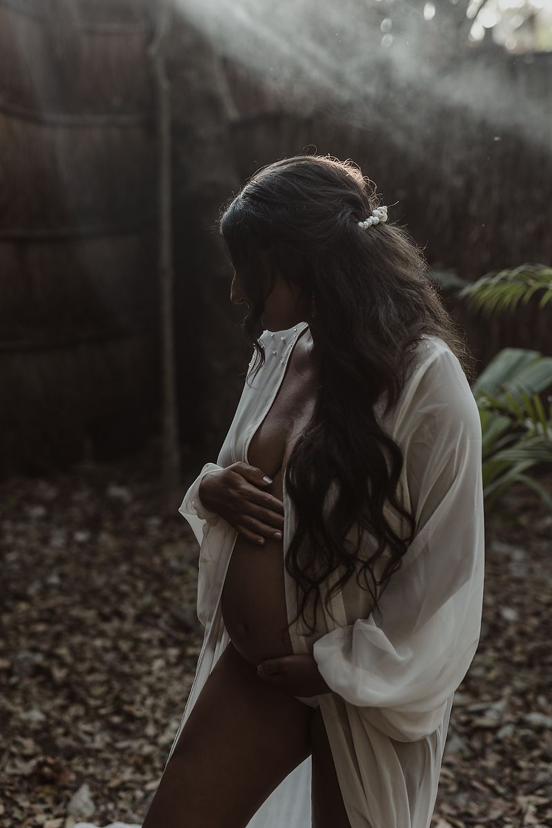 Luxury maternity portrait surrounded by tropical jungle in Mexico.