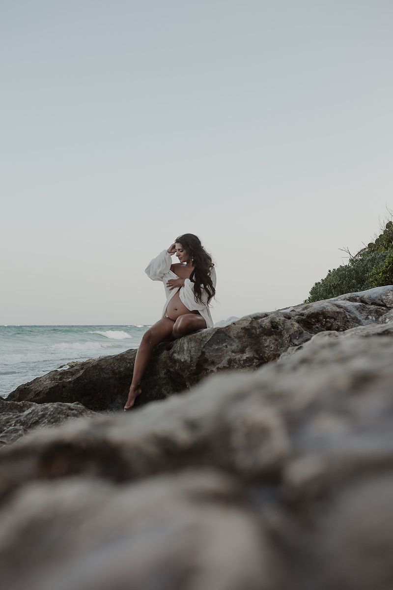 Editorial pregnancy portrait by the ocean in Tulum Riviera Maya.