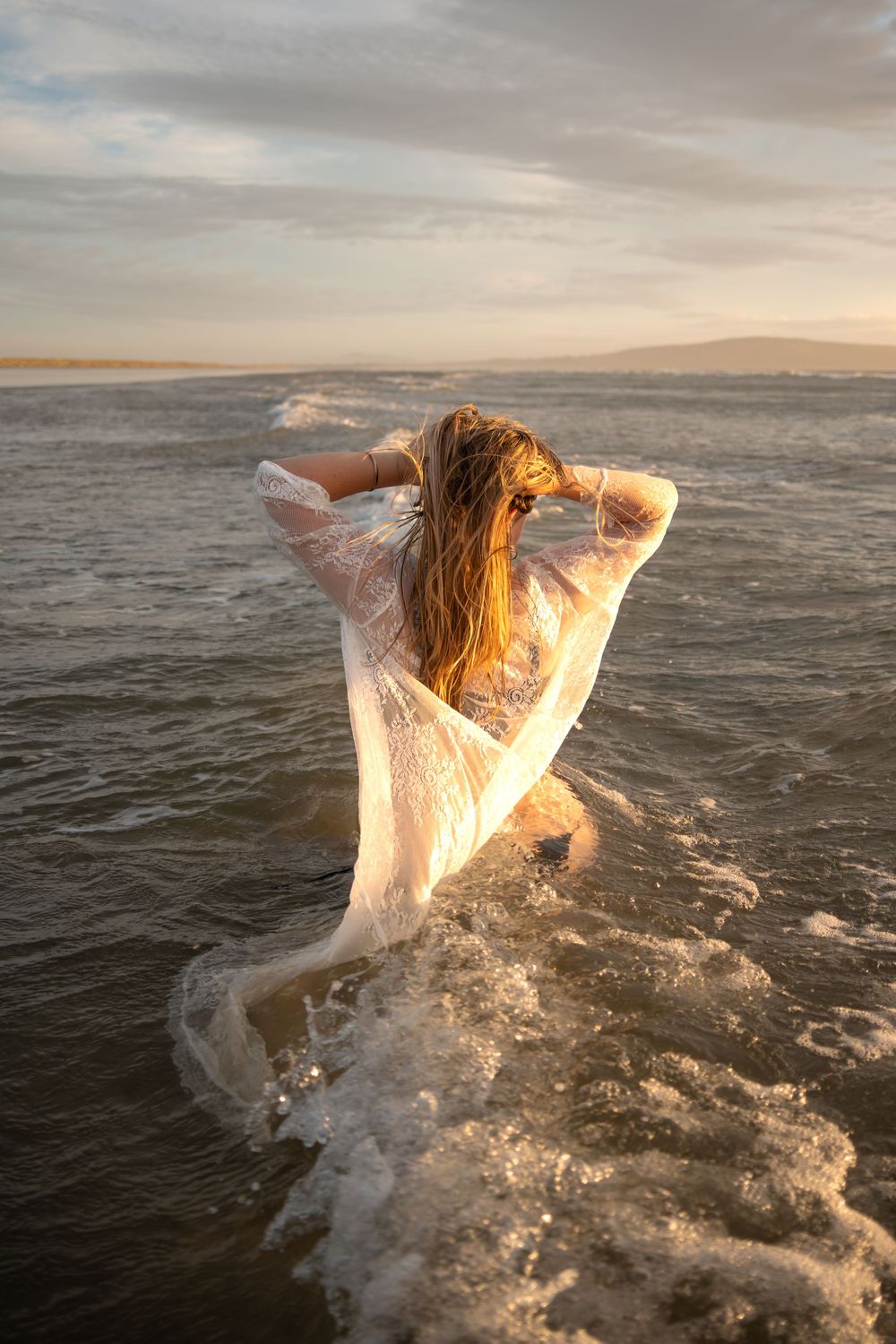 woman standing in the ocean
