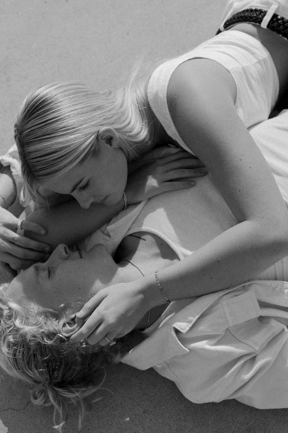 Intimate black and white portrait of two people in a tender moment.