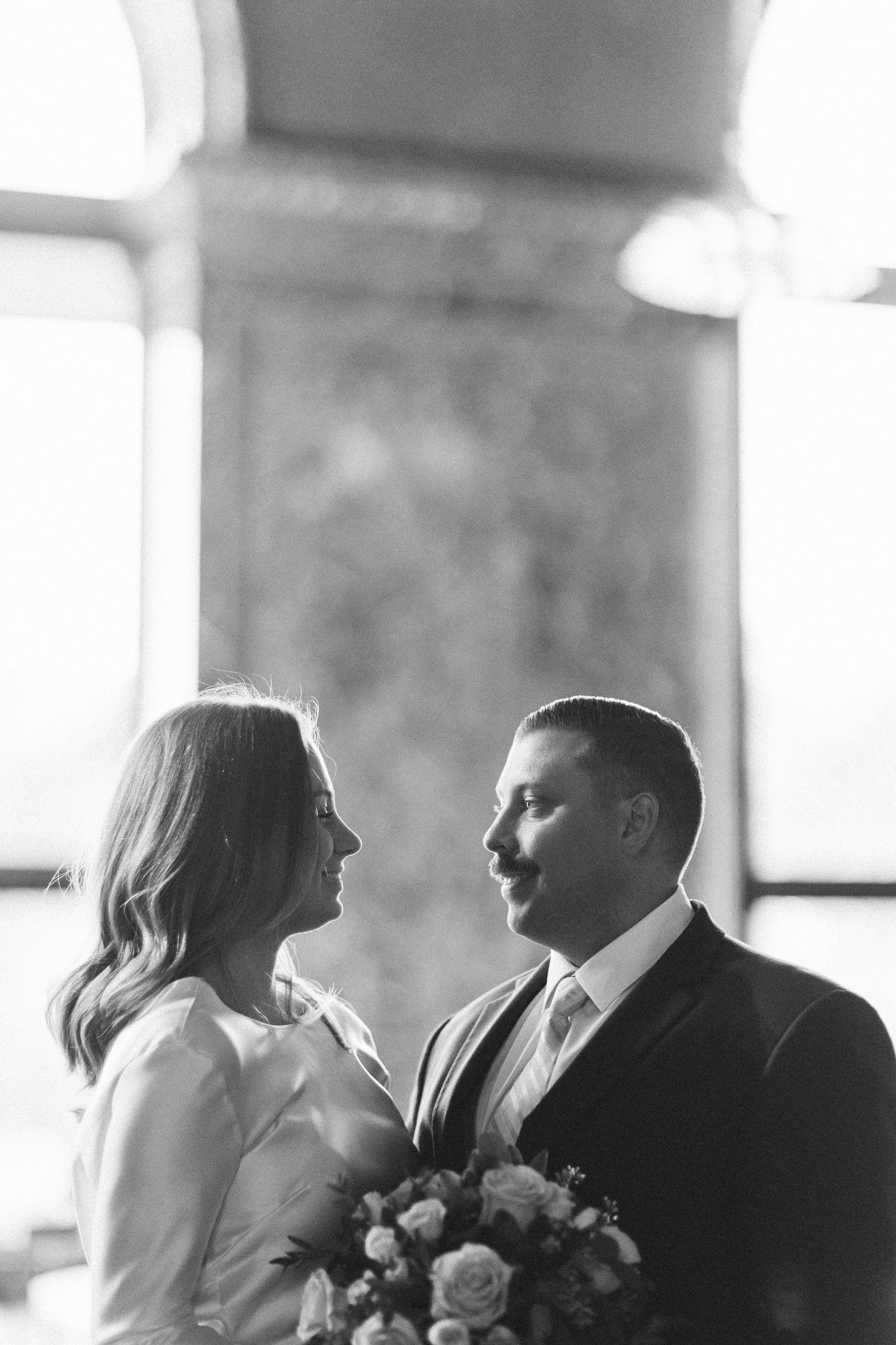 Black and white intimate wedding portrait capturing tender moment.