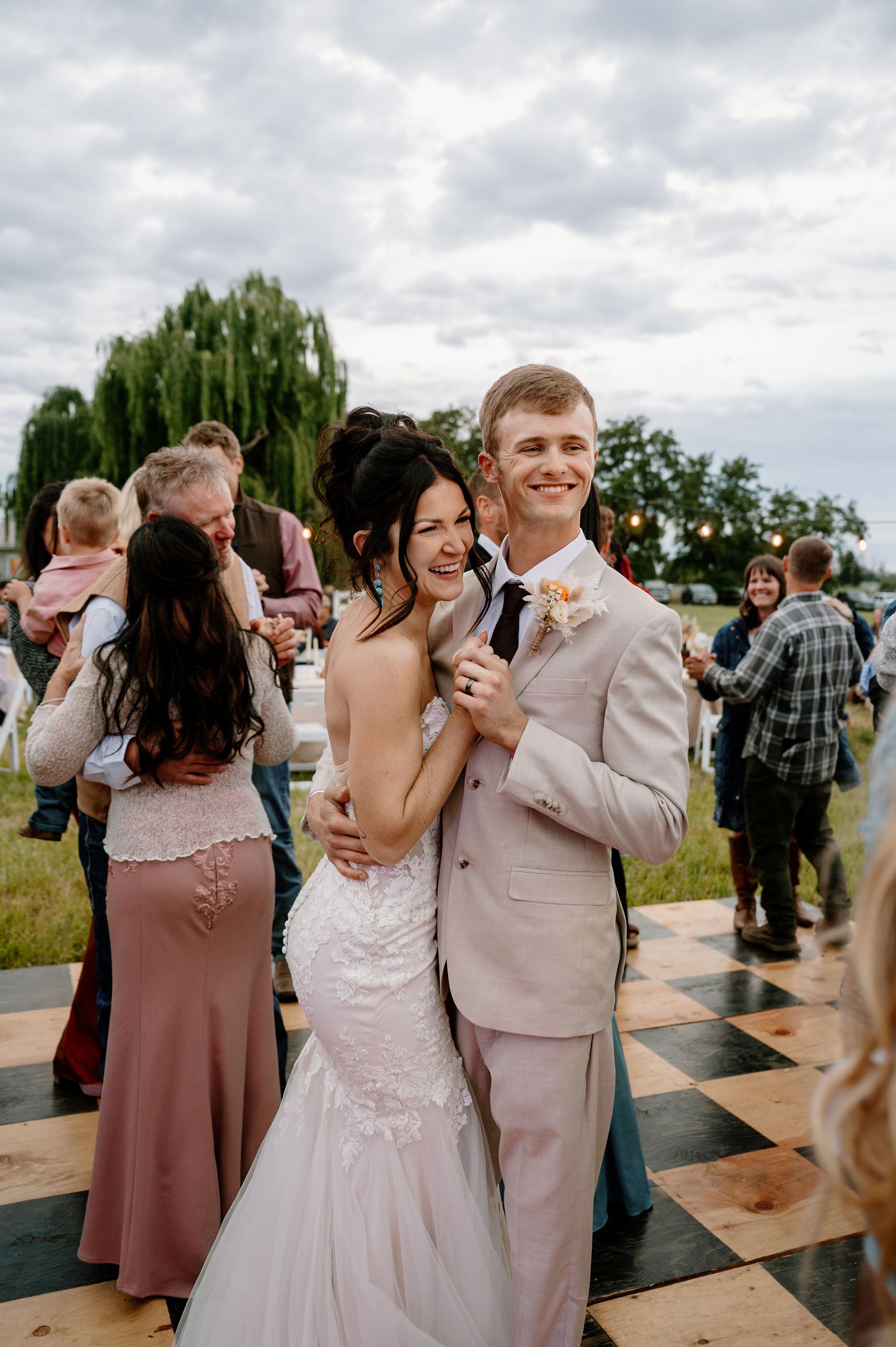 Overcast outdoor wedding reception with a checkered dance floor