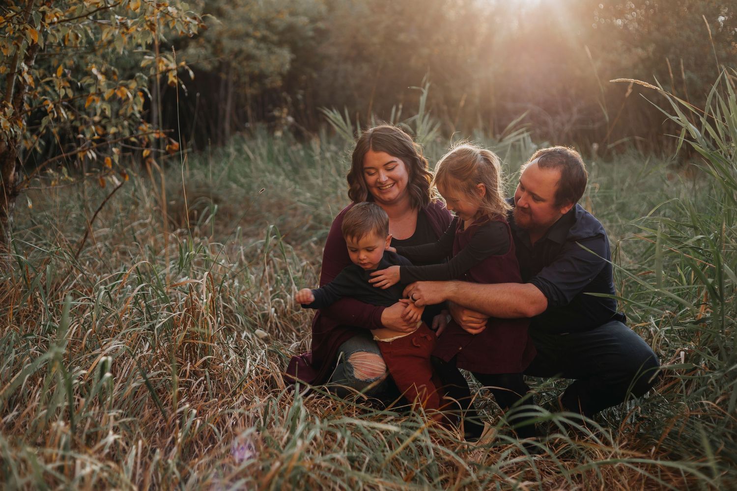 A collection of intimate family portraits taken outdoors during golden hour in a natural field setting.