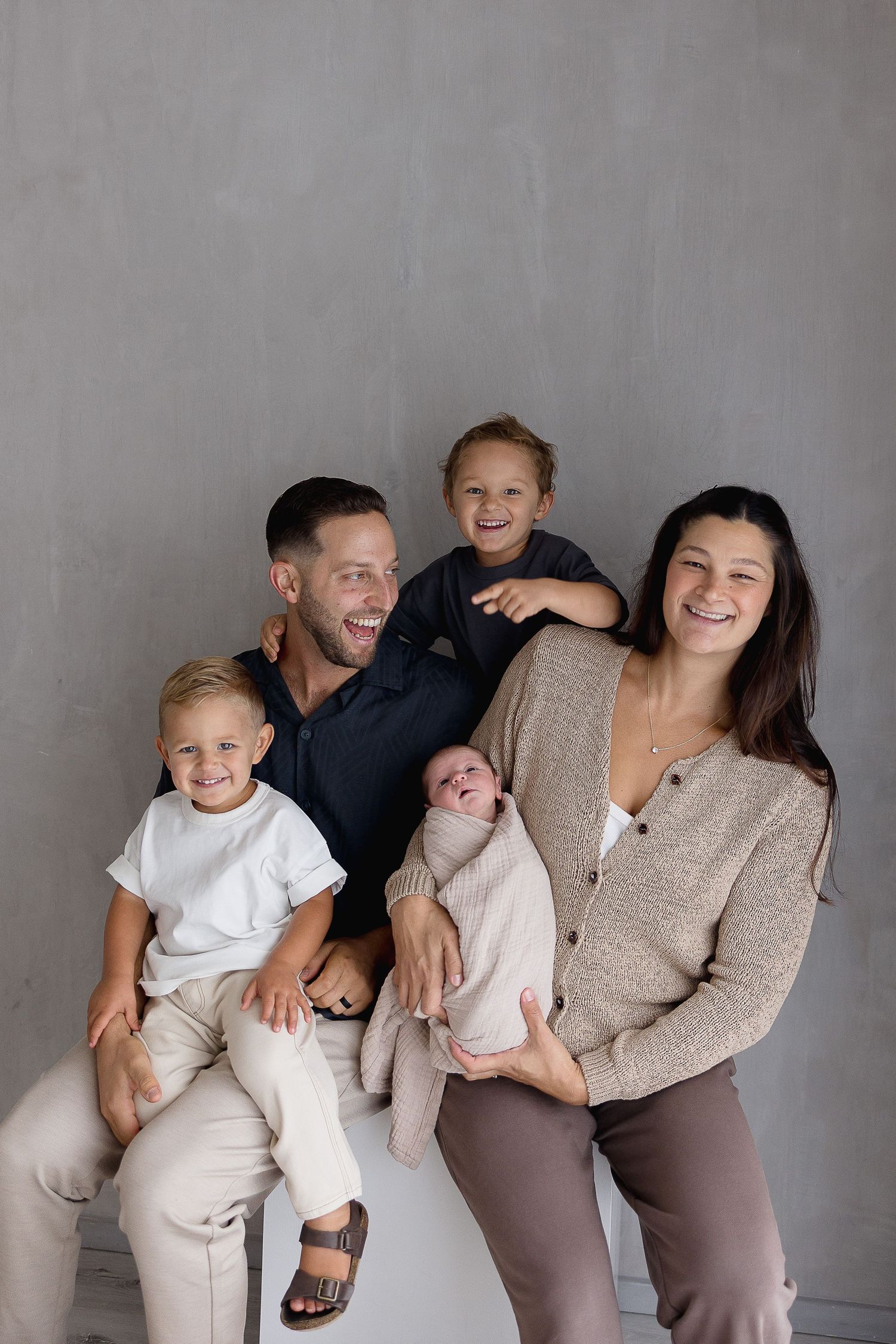 Family of 5 picture poses with newborn at Orange County photo studio