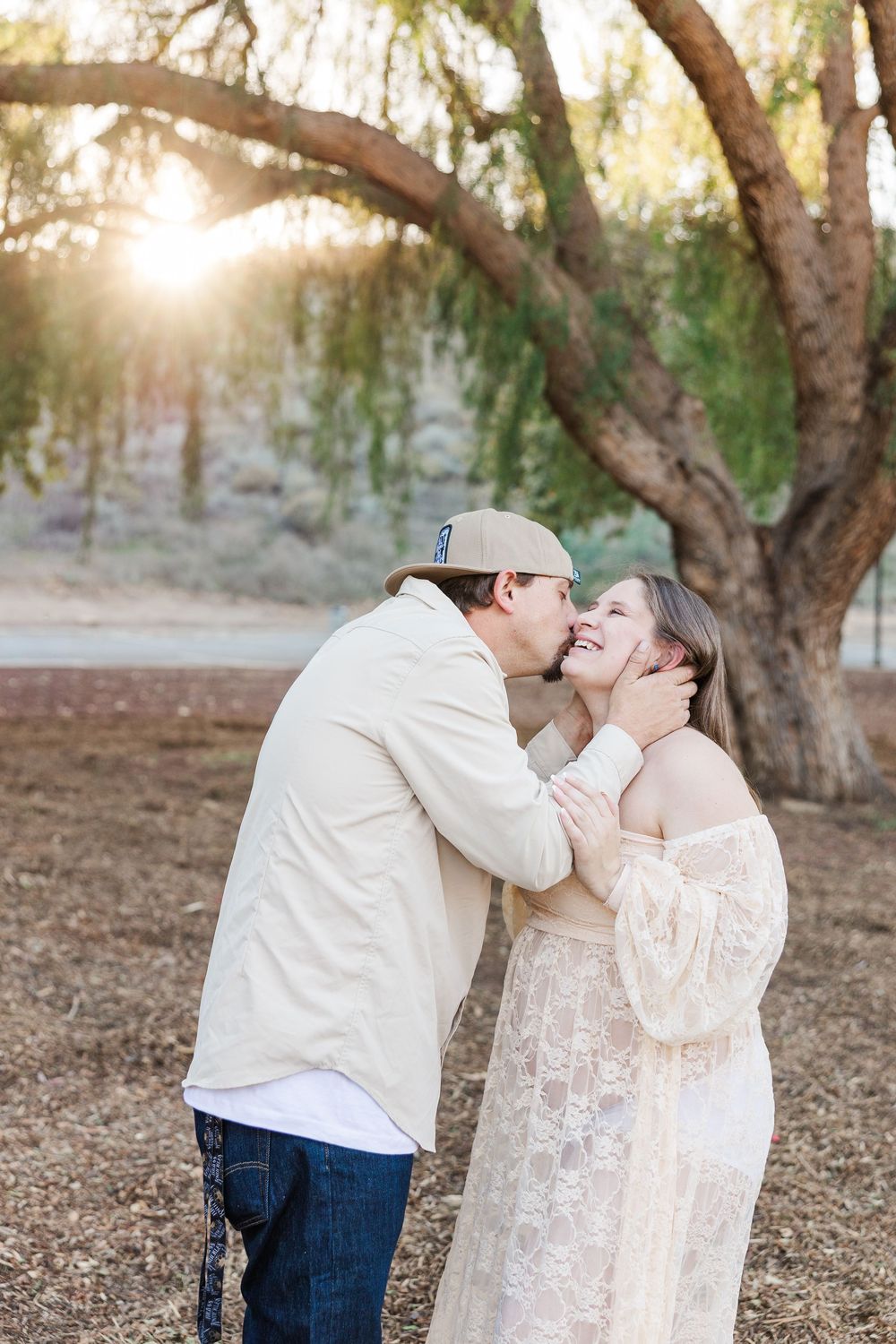 Sweet candid moments captured between a couple in white and denim against a natural outdoor backdrop.