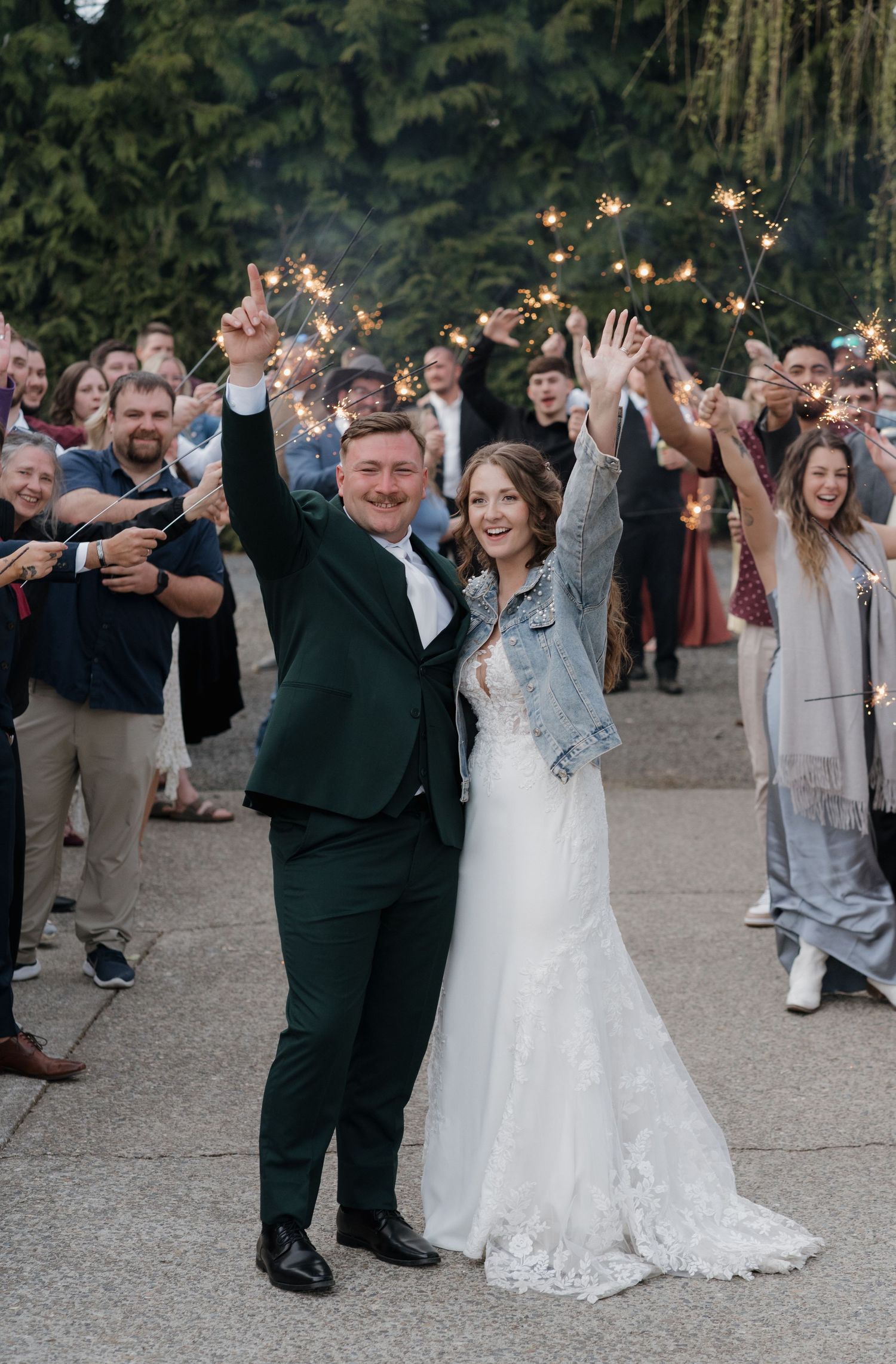 Wedding celebration sequence shows guests dancing and waving sparklers during an outdoor evening reception. Leavenworth, WA